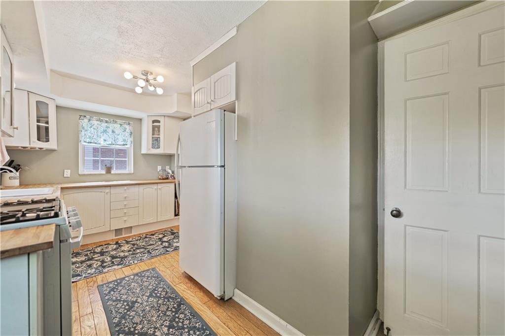 569 Kenilworth Drive Pittsburgh, PA 15228 - Photo 15 of 29 a kitchen with a refrigerator and a stove top oven