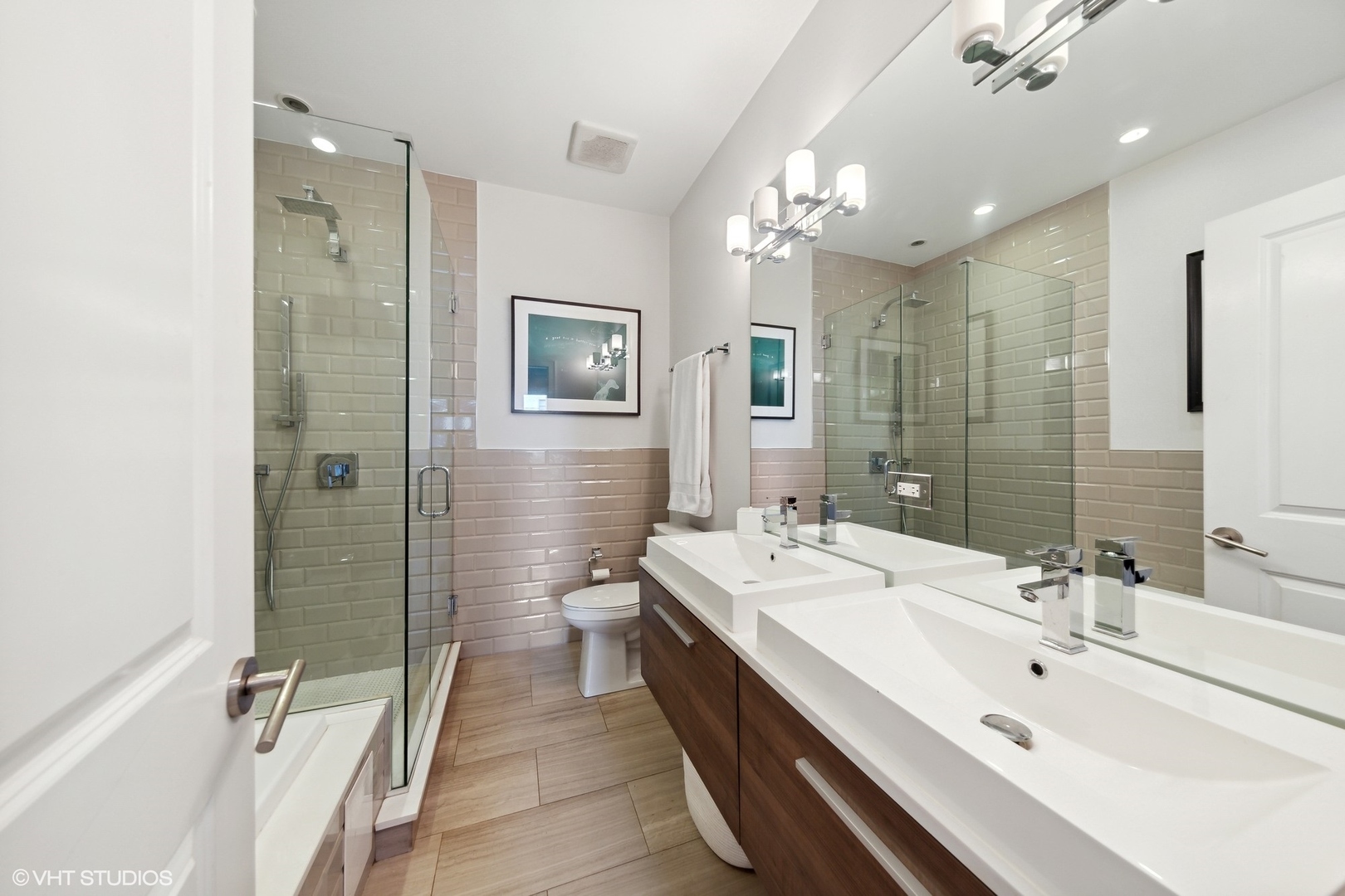 2548 West Irving Park Road, Unit 1E Chicago, IL 60618 - Photo 13 of 17 a spacious bathroom with a double vanity sink toilet and shower