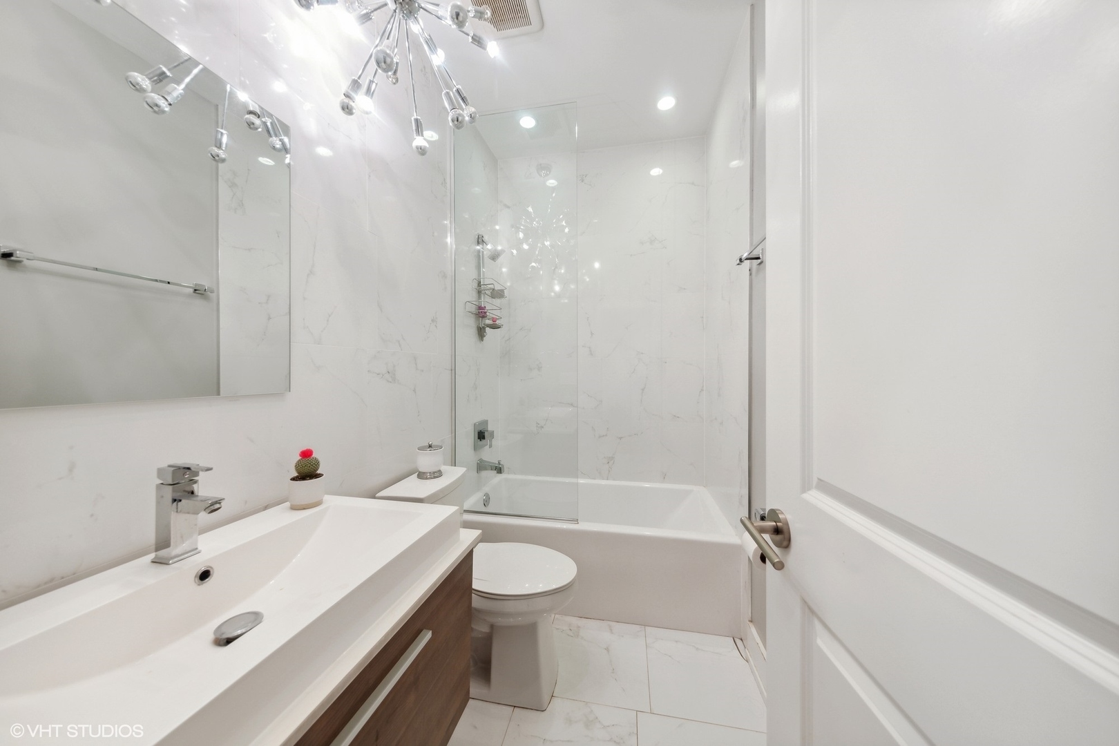 2548 West Irving Park Road, Unit 1E Chicago, IL 60618 - Photo 15 of 17 a bathroom with a sink a toilet and shower