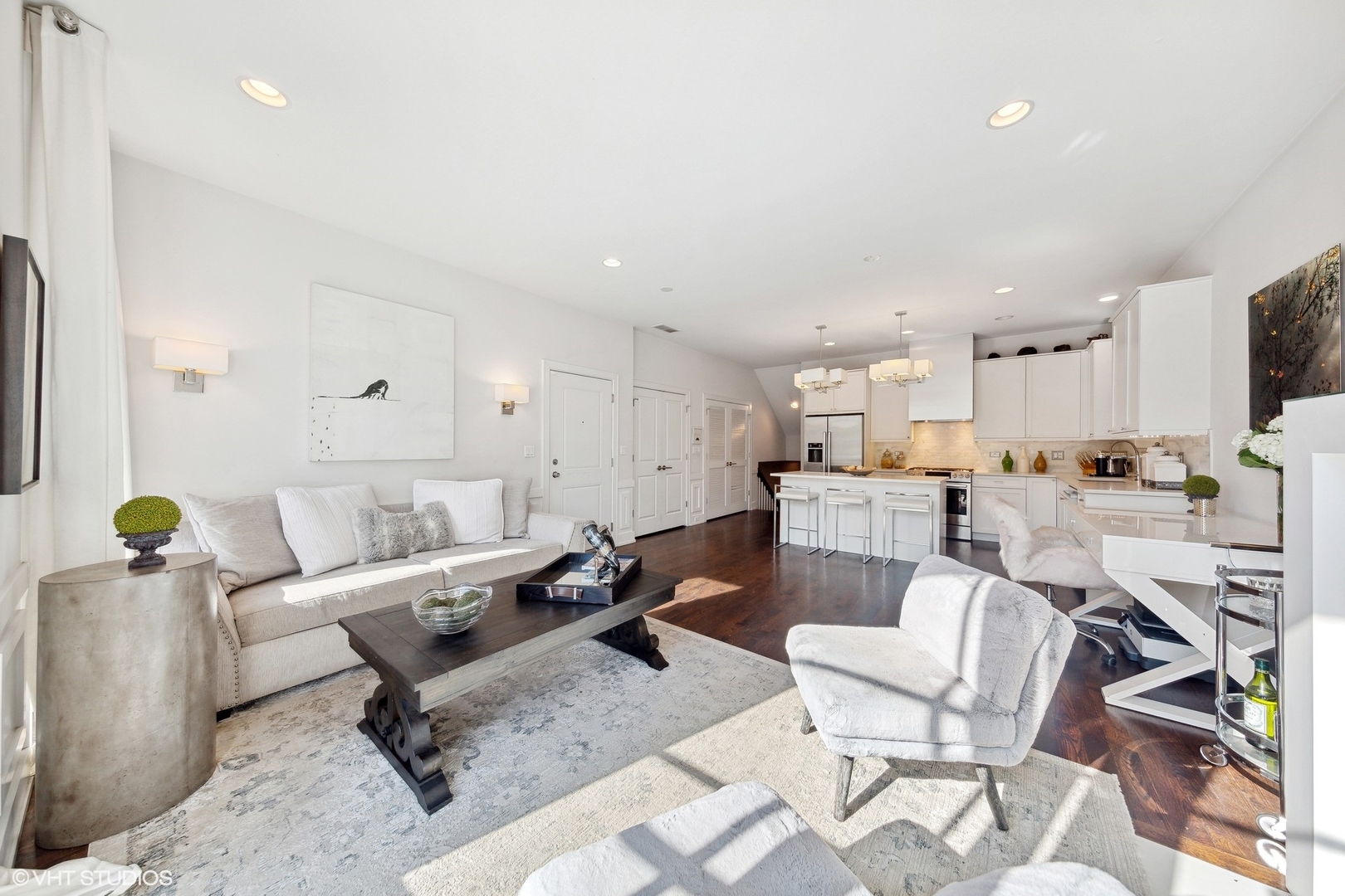2548 West Irving Park Road, Unit 1E Chicago, IL 60618 - Photo 4 of 17 a living room with furniture and a dining table with kitchen view