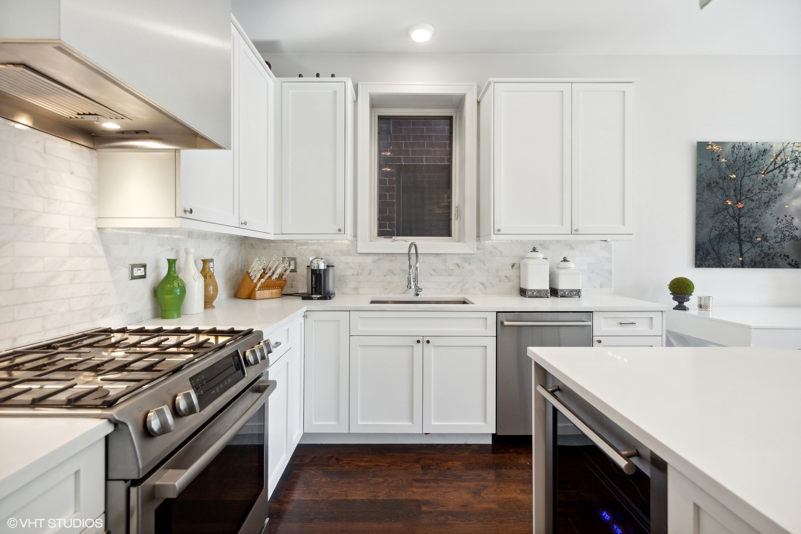 2548 West Irving Park Road, Unit 1E Chicago, IL 60618 - Photo 7 of 17 a kitchen with granite countertop a sink stove and cabinets