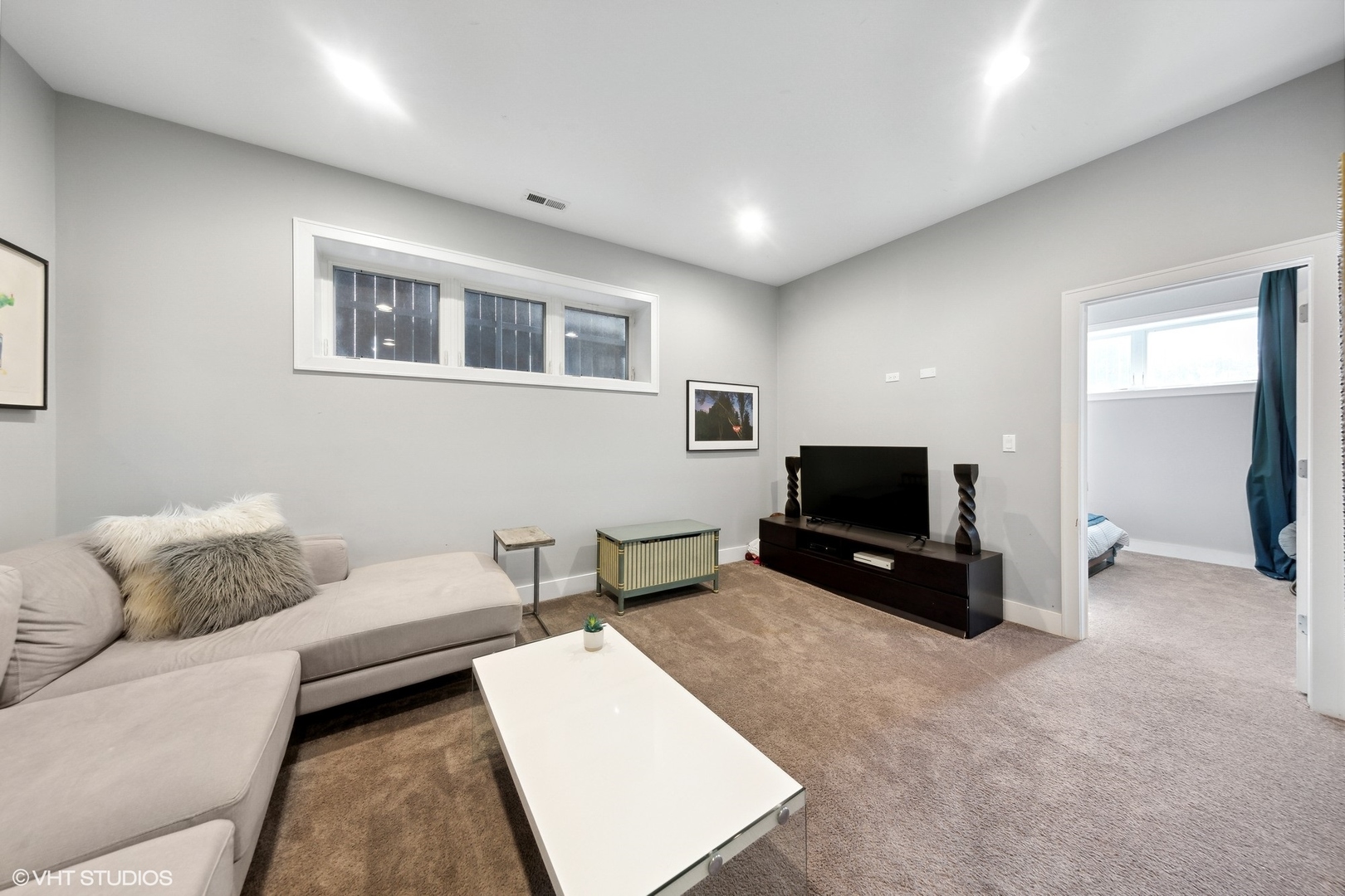 2548 West Irving Park Road, Unit 1E Chicago, IL 60618 - Photo 10 of 17 a living room with furniture and a flat screen tv