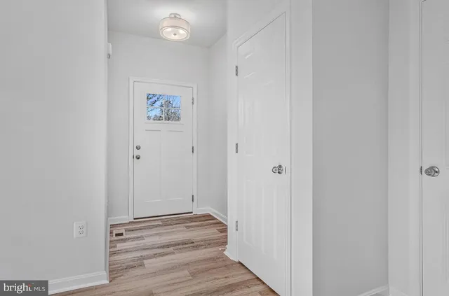 a view of a hallway with wooden floor