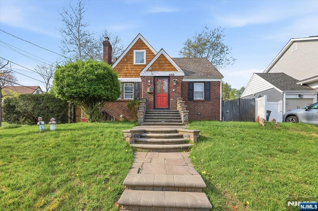 409 Tryon Avenue Englewood, NJ 07631 - Photo 1 of 33 a front view of a house with a yard