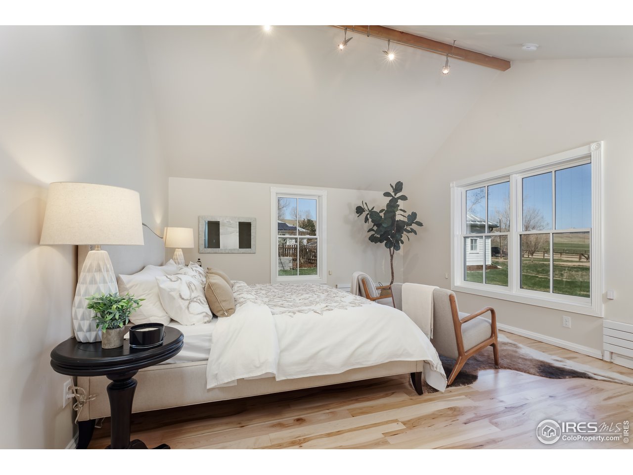5629 Prospect Road Niwot, CO 80503 - Photo 13 of 40 a bedroom with a bed window and potted plant