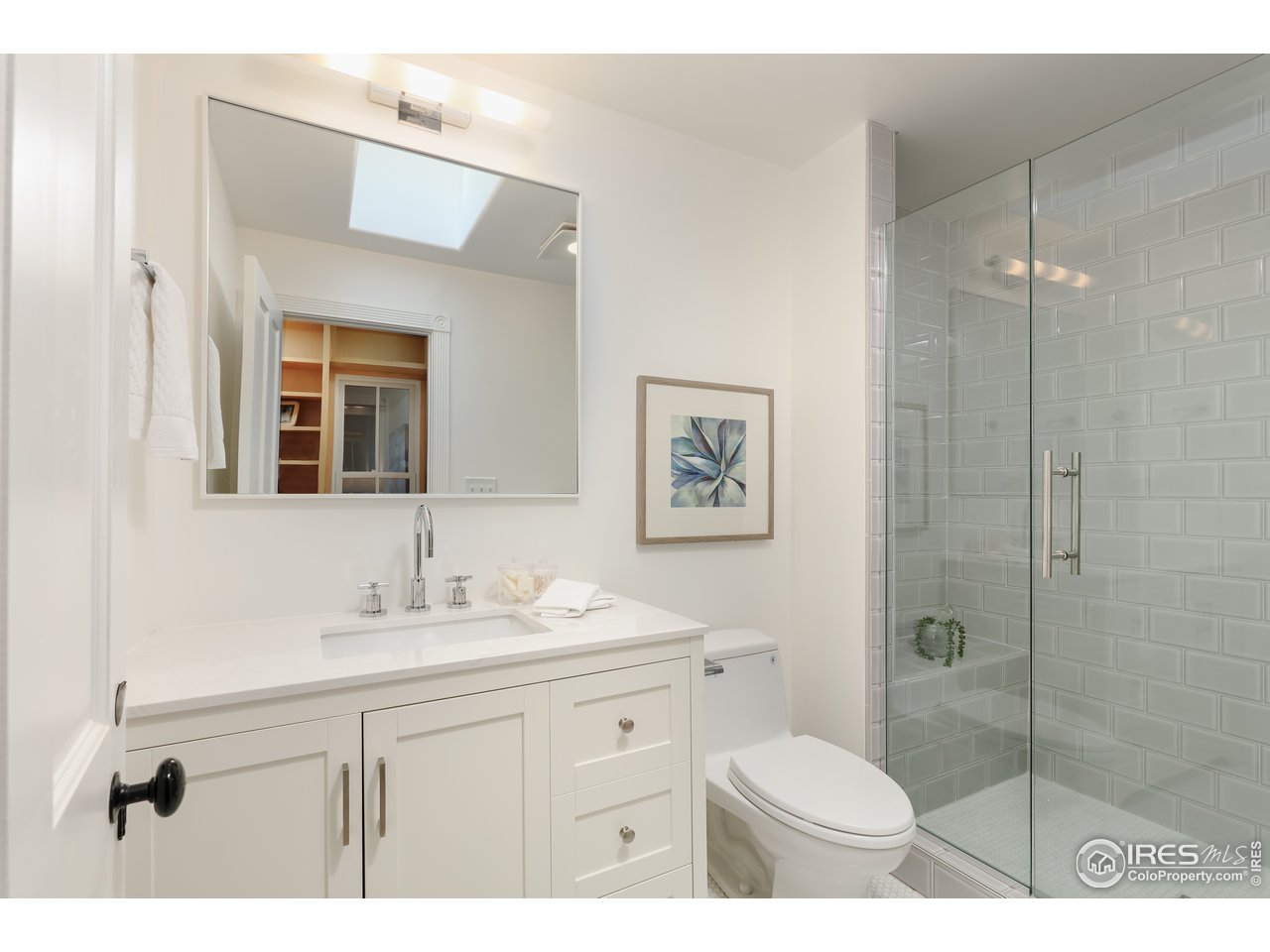 5629 Prospect Road Niwot, CO 80503 - Photo 18 of 40 a bathroom with a sink a toilet a shower and a mirror