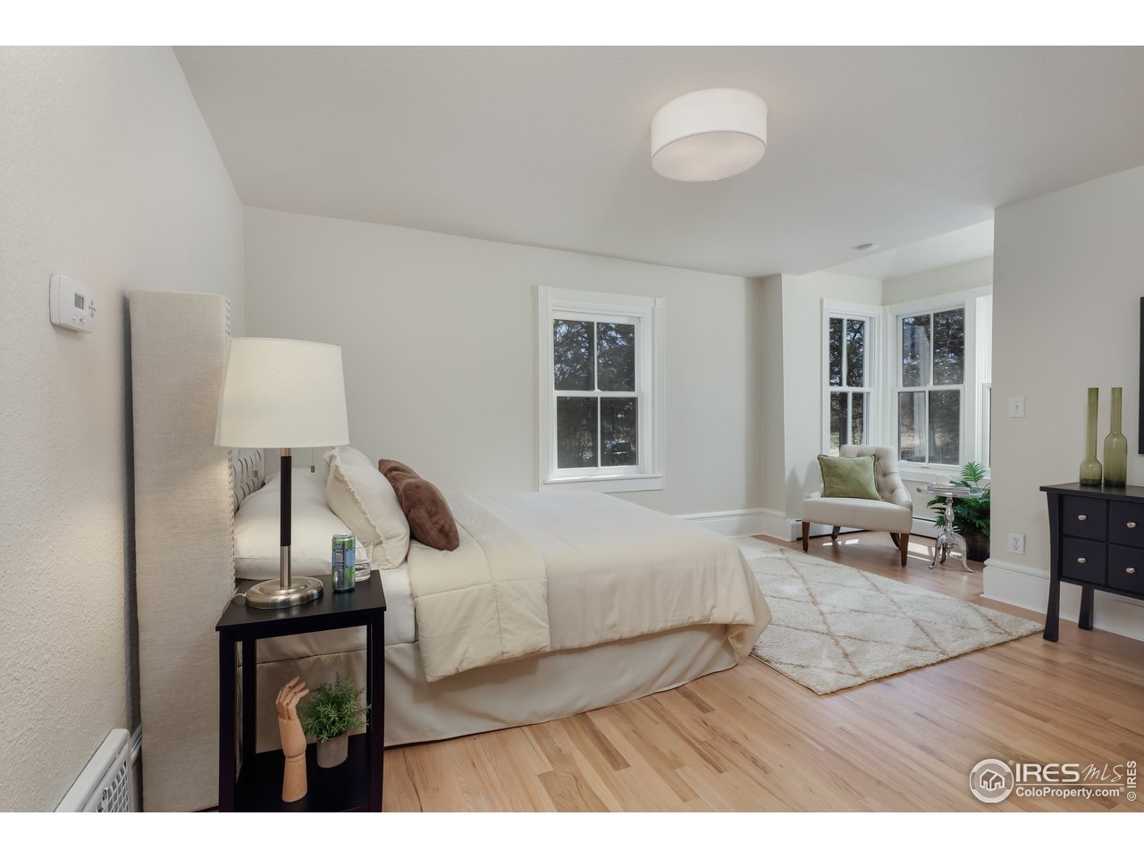 5629 Prospect Road Niwot, CO 80503 - Photo 19 of 40 a bedroom with a bed window and chair