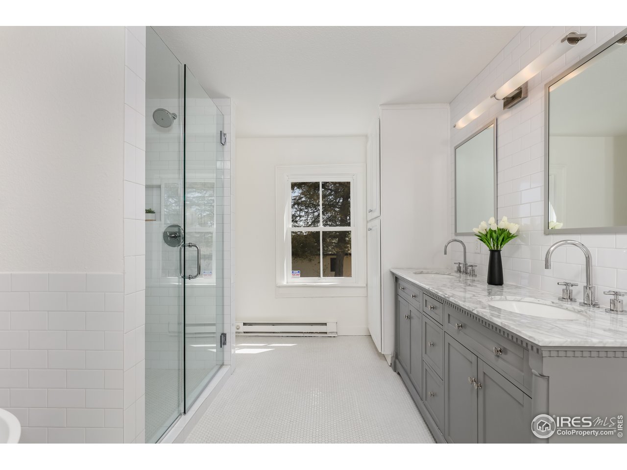 5629 Prospect Road Niwot, CO 80503 - Photo 20 of 40 a bathroom with a granite countertop sink mirror and a shower