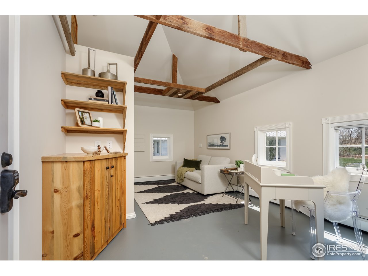 5629 Prospect Road Niwot, CO 80503 - Photo 29 of 40 a living room with couches a dining table and chairs with wooden floor