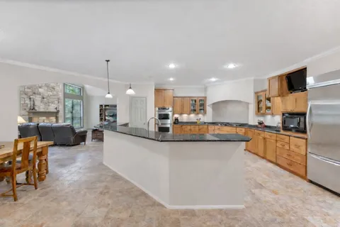 a view of a livingroom with wooden floor and a ceiling fan