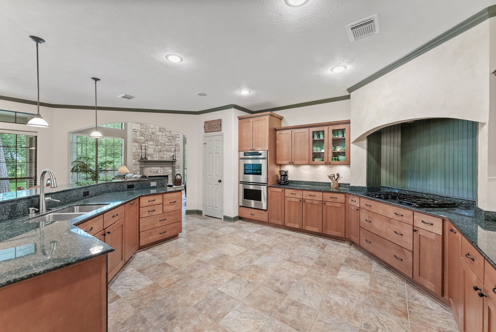 24311 Standing Oak Drive Spring, TX 77389 - Photo 17 of 41 a large kitchen with kitchen island granite countertop a large counter top stainless steel appliances a sink and cabinets
