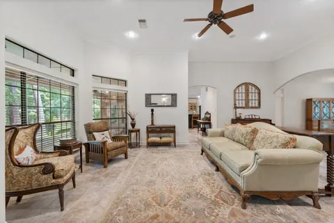 a spacious bedroom with a bed and a chandelier