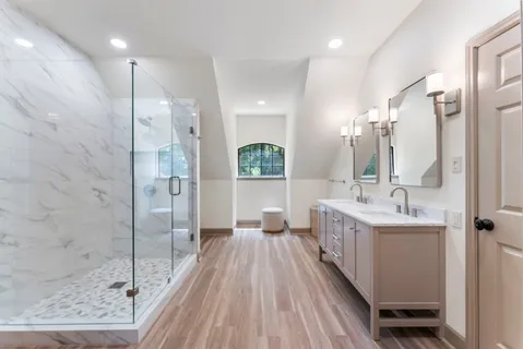 a view of a patio with table and chairs potted plants and large tree