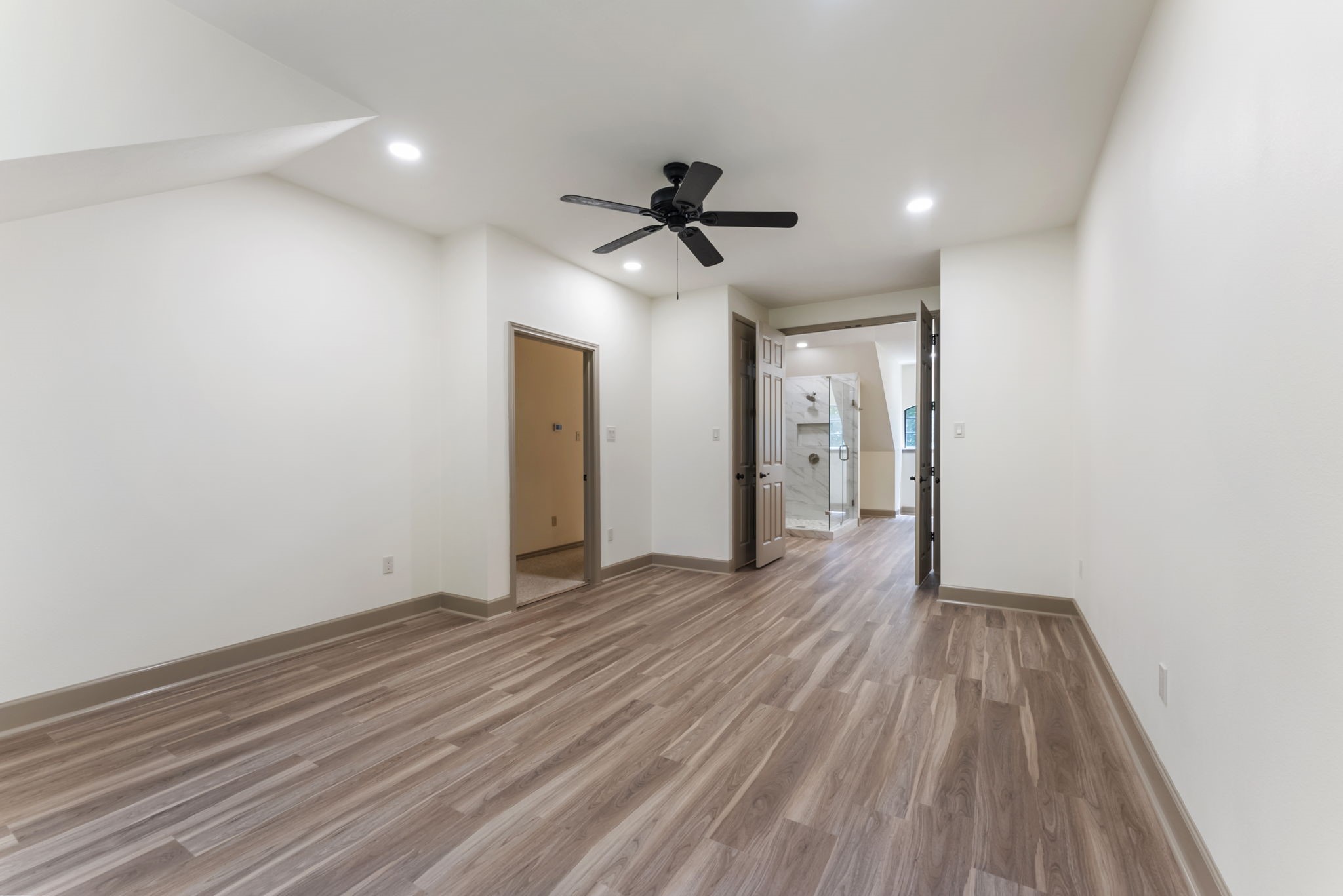 24311 Standing Oak Drive Spring, TX 77389 - Photo 25 of 41 a view of a livingroom with wooden floor and a ceiling fan