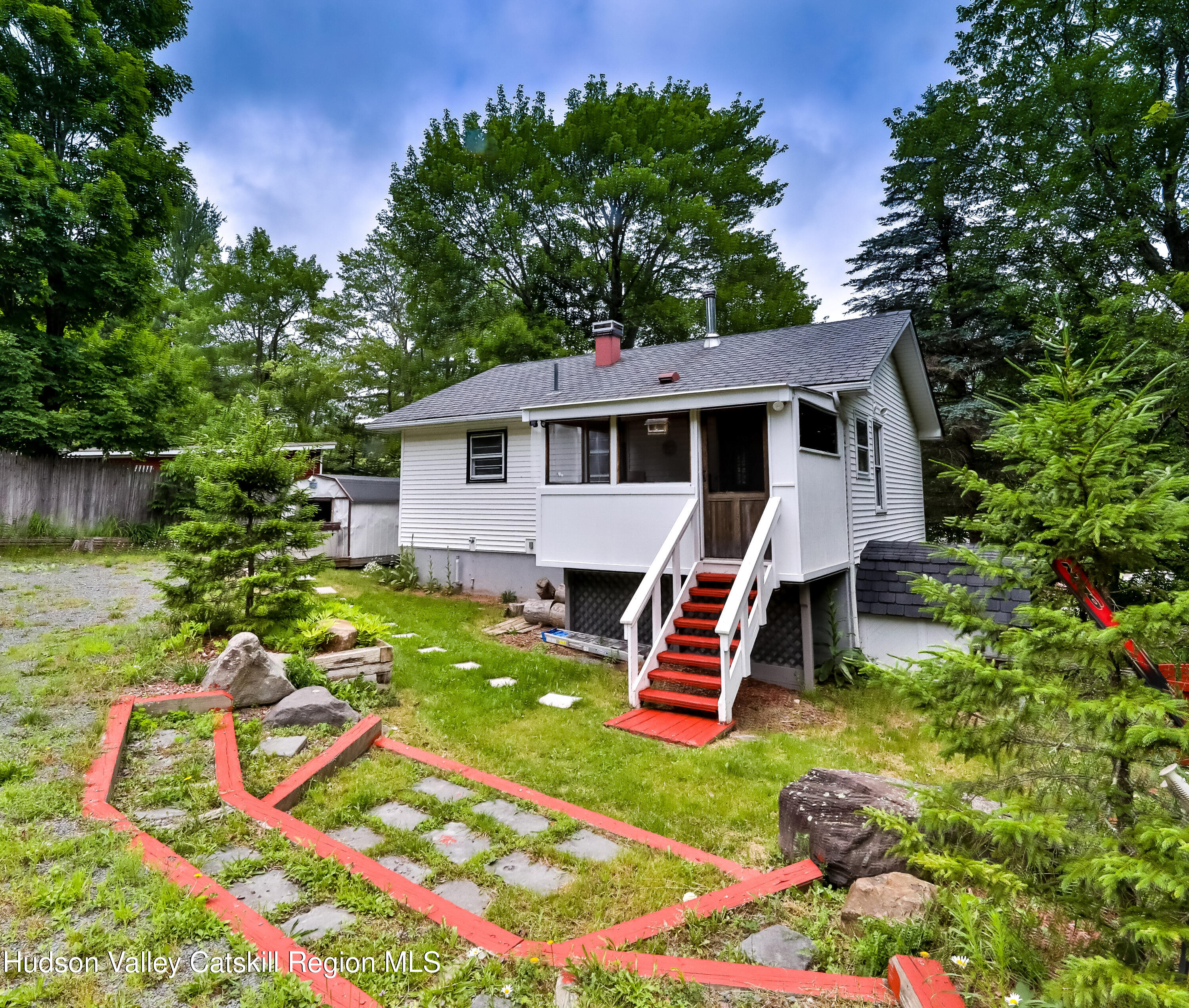 a view of a backyard with plants and a patio