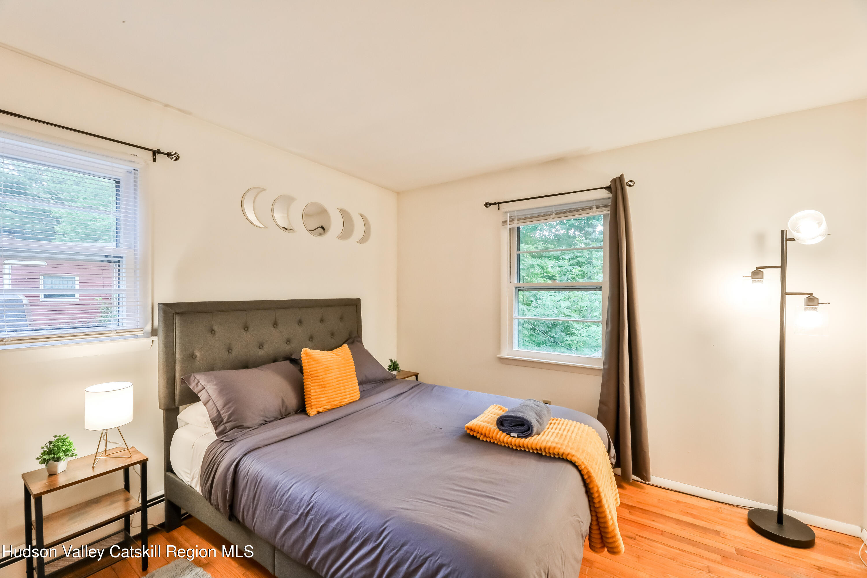 89 Maple Avenue Hunter, NY 12442 - Photo 20 of 41 a bedroom with a bed and wooden floor