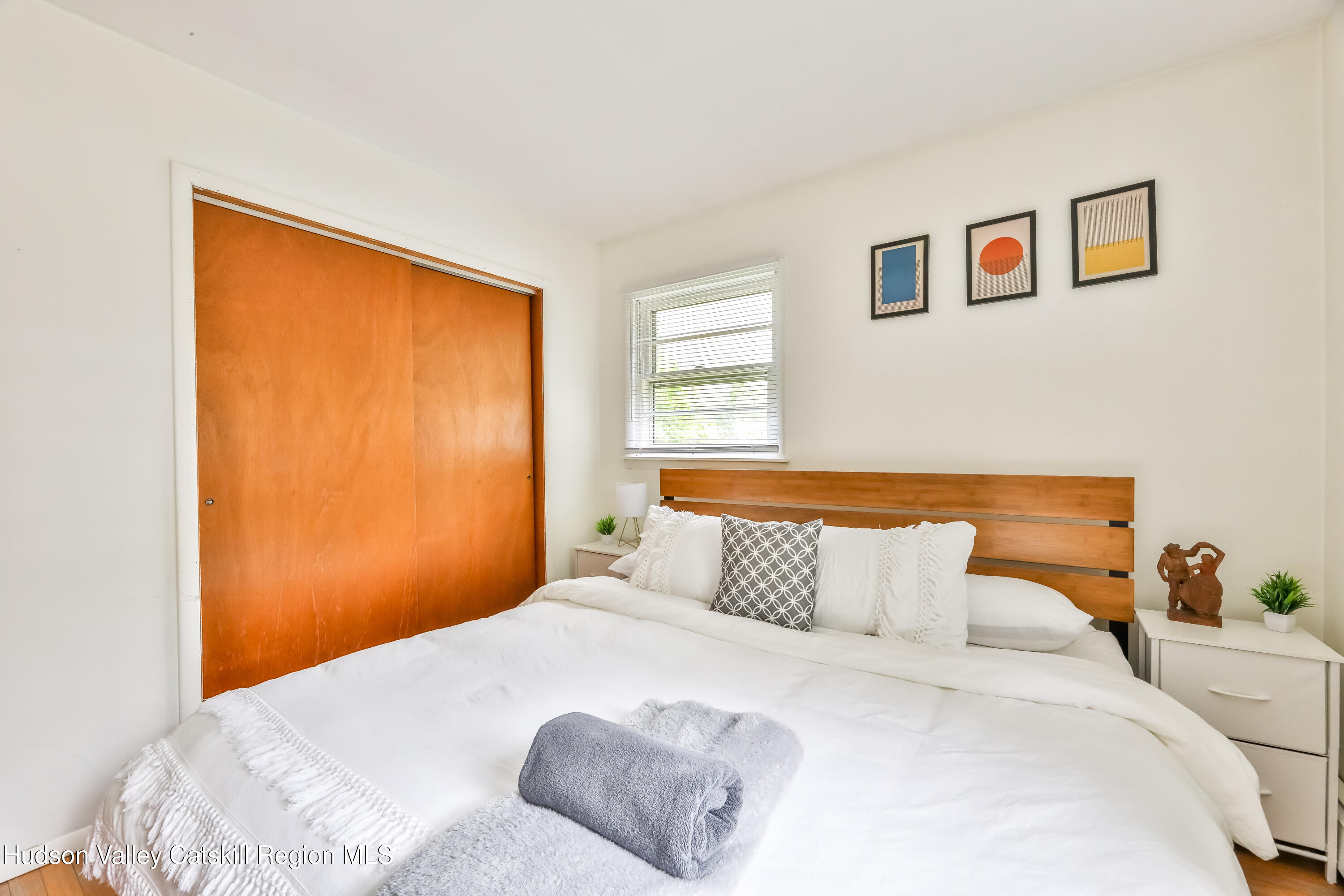 89 Maple Avenue Hunter, NY 12442 - Photo 24 of 41 a bedroom with a large bed and a window