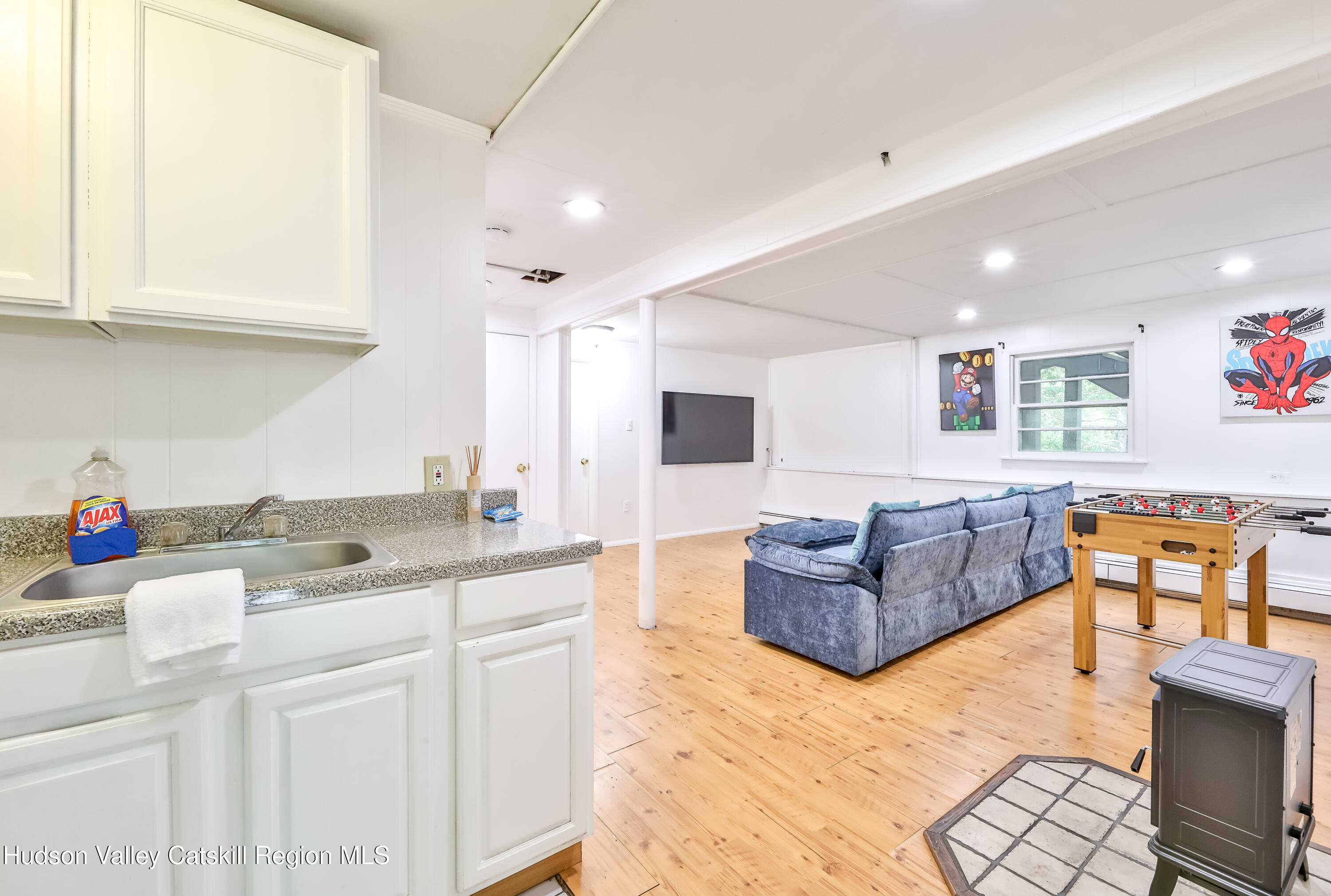 89 Maple Avenue Hunter, NY 12442 - Photo 26 of 41 a spacious bathroom with a granite countertop sink and a mirror