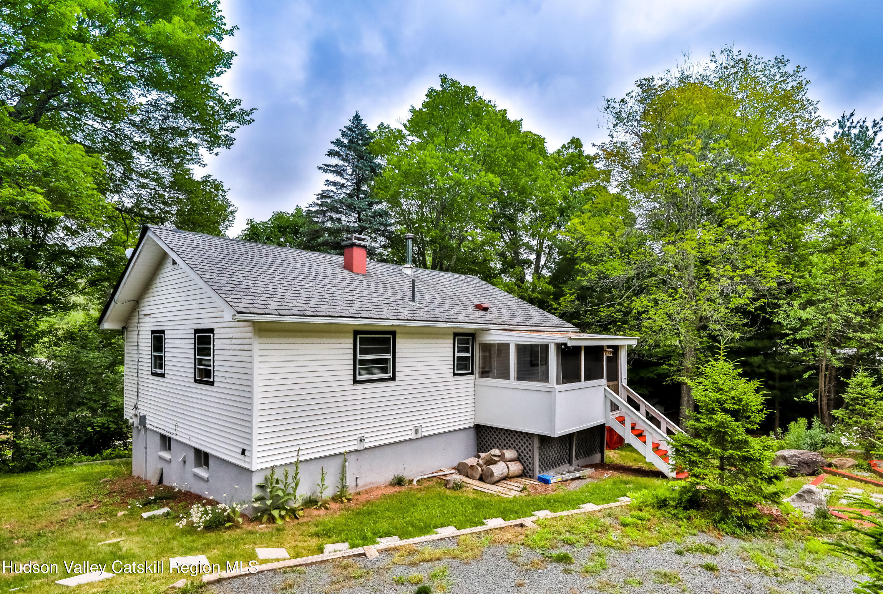 89 Maple Avenue Hunter, NY 12442 - Photo 3 of 41 a front view of a house with a yard table and chairs