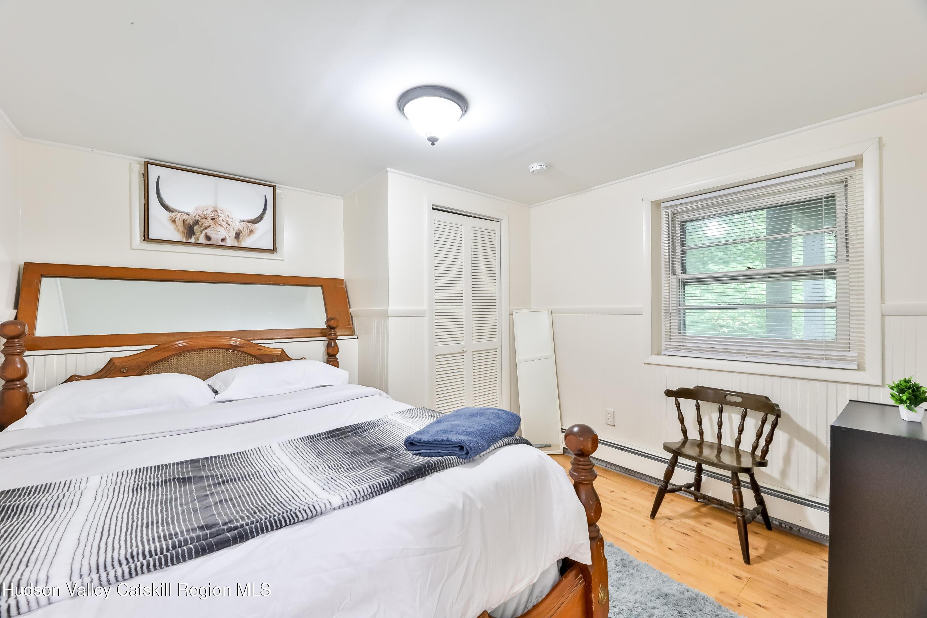 89 Maple Avenue Hunter, NY 12442 - Photo 33 of 41 a bedroom with a large bed and a couch