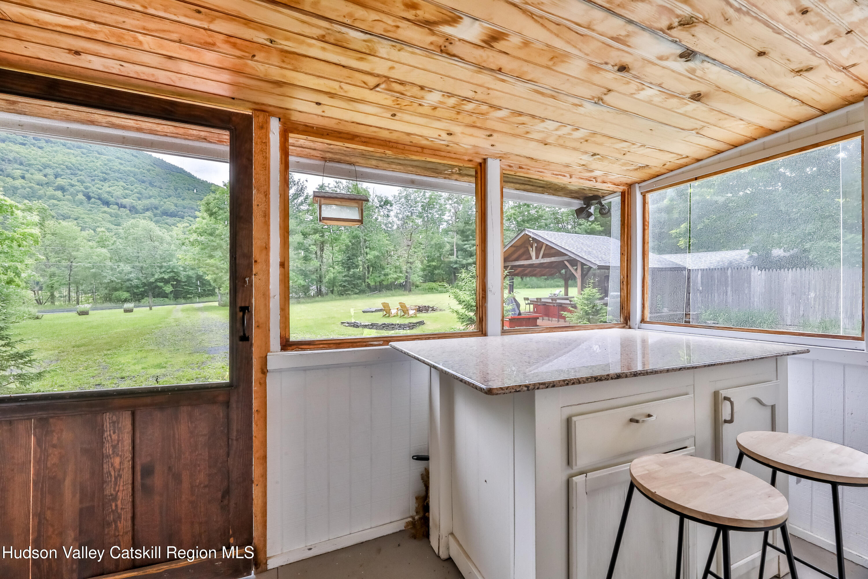 89 Maple Avenue Hunter, NY 12442 - Photo 7 of 41 a kitchen with a wooden floor and outdoor space