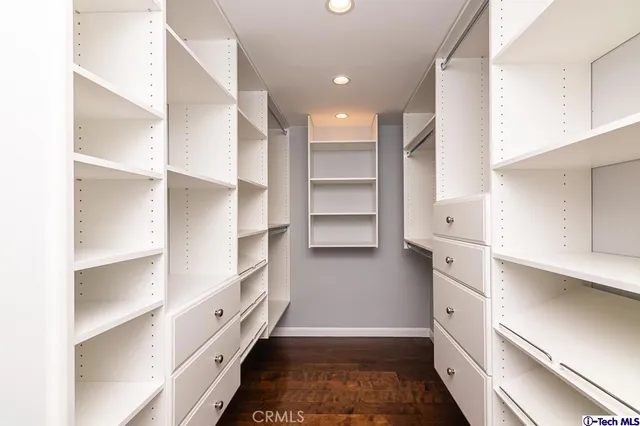 a kitchen with white cabinets and counter space