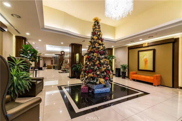 a room with lots of potted plants and a fireplace