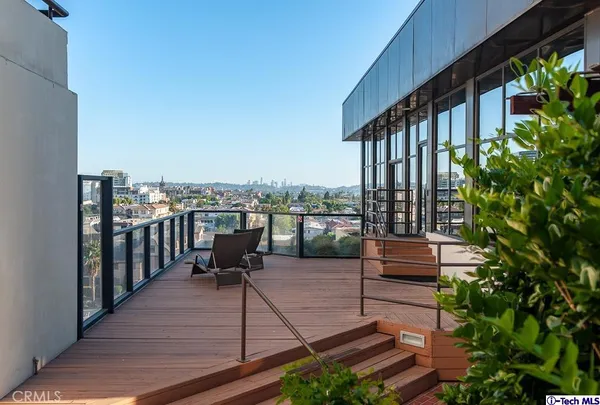 a terrace with outdoor seating and city view