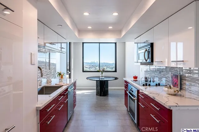 a kitchen with a sink stove top oven and microwave