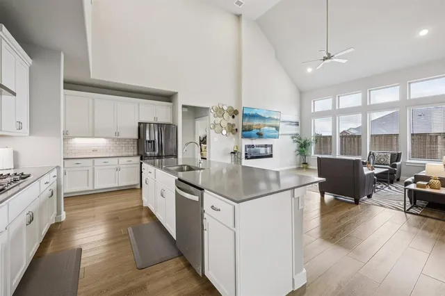 a kitchen with stainless steel appliances granite countertop a stove and more cabinets