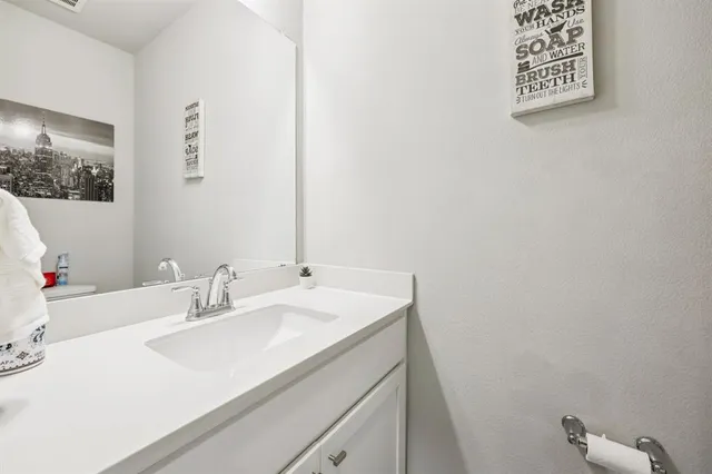 a bathroom with a sink vanity and a toilet