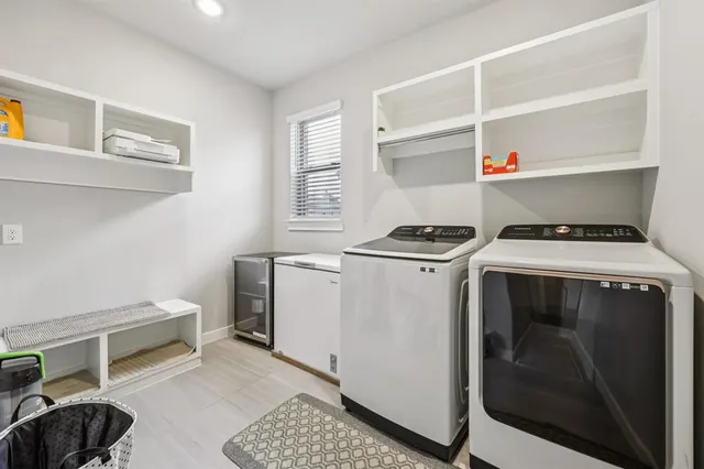 a utility room with sink dryer and washer