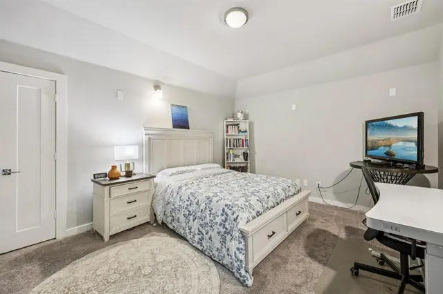 a living room with a bed and a flat screen tv