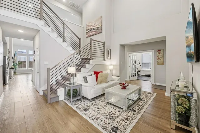 a living room with furniture and wooden floor