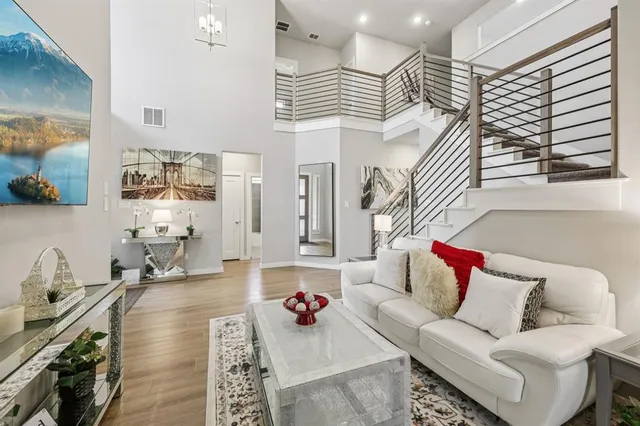 a living room with furniture and wooden floor