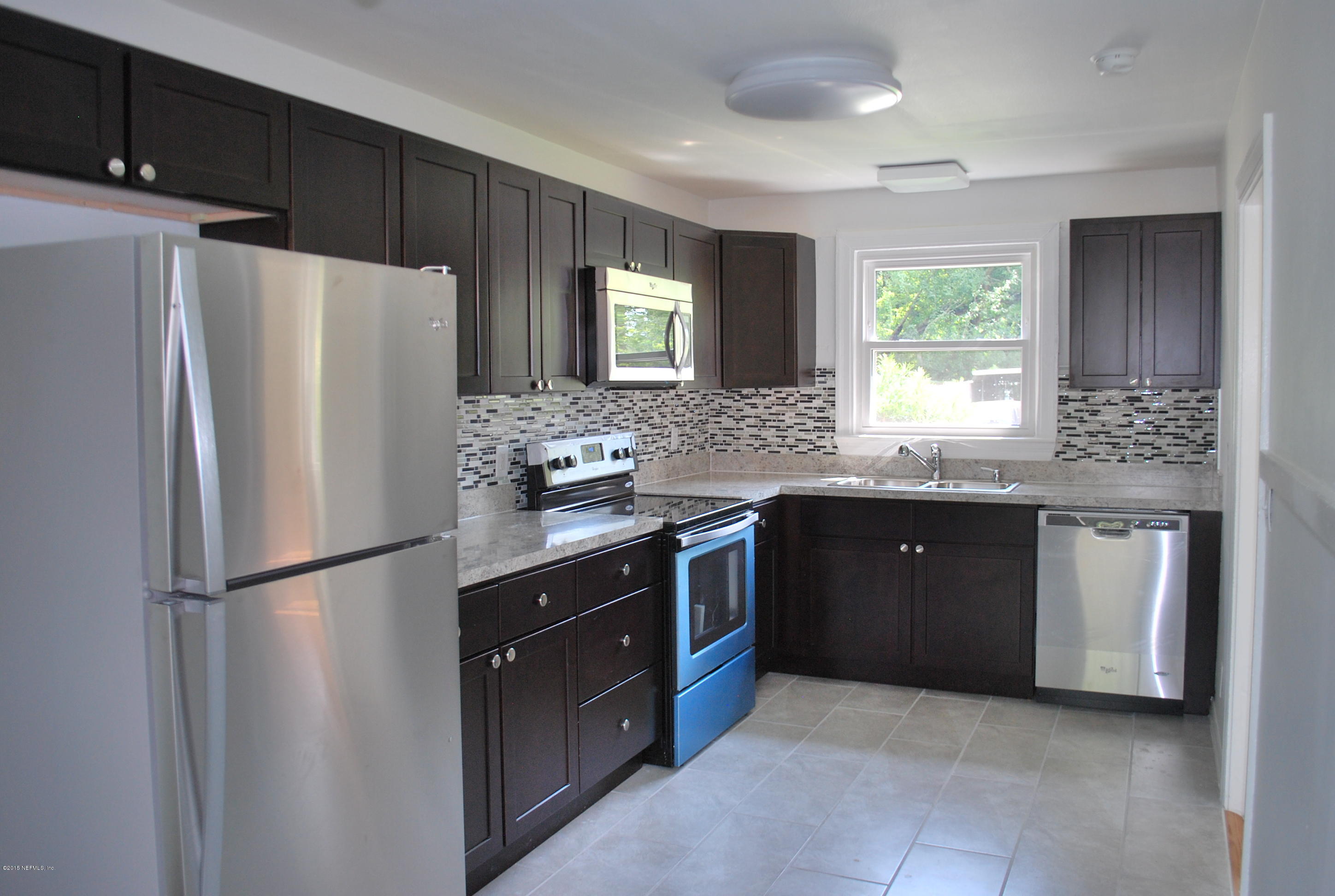 4603 Sunderland Road Jacksonville, FL 32210 - Photo 1 of 20 a kitchen with stainless steel appliances granite countertop a refrigerator stove a sink and a granite counter tops