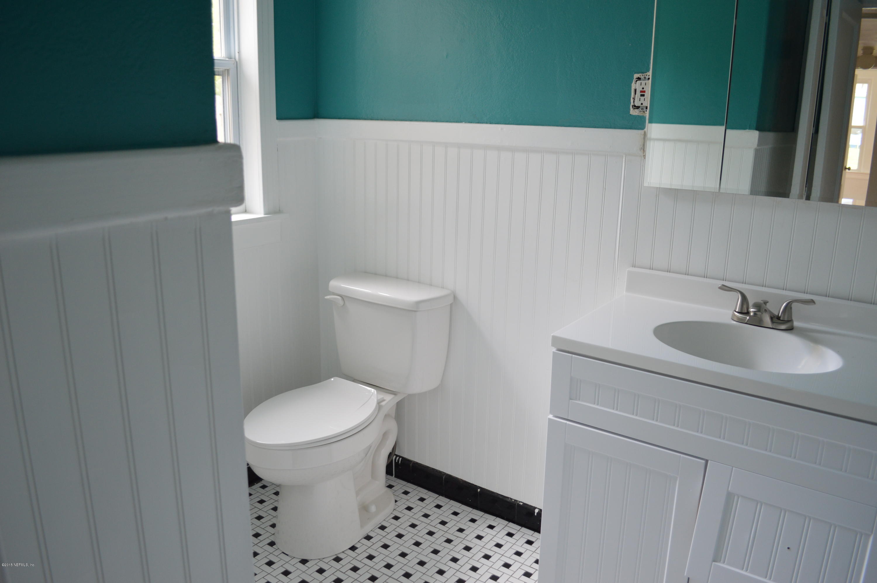 4603 Sunderland Road Jacksonville, FL 32210 - Photo 16 of 20 a bathroom with a sink a toilet and a mirror