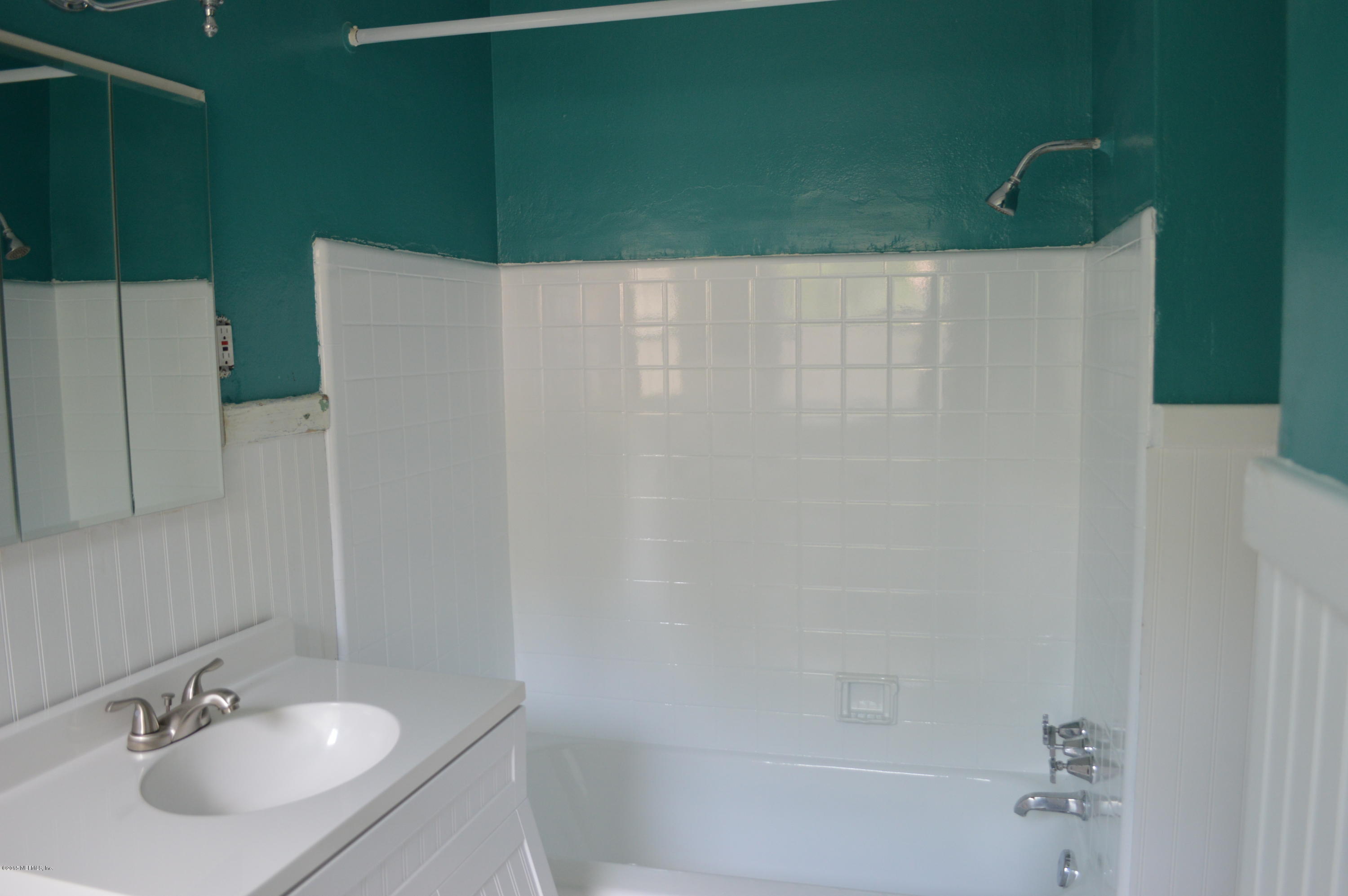 4603 Sunderland Road Jacksonville, FL 32210 - Photo 17 of 20 a bathroom with a sink and a mirror