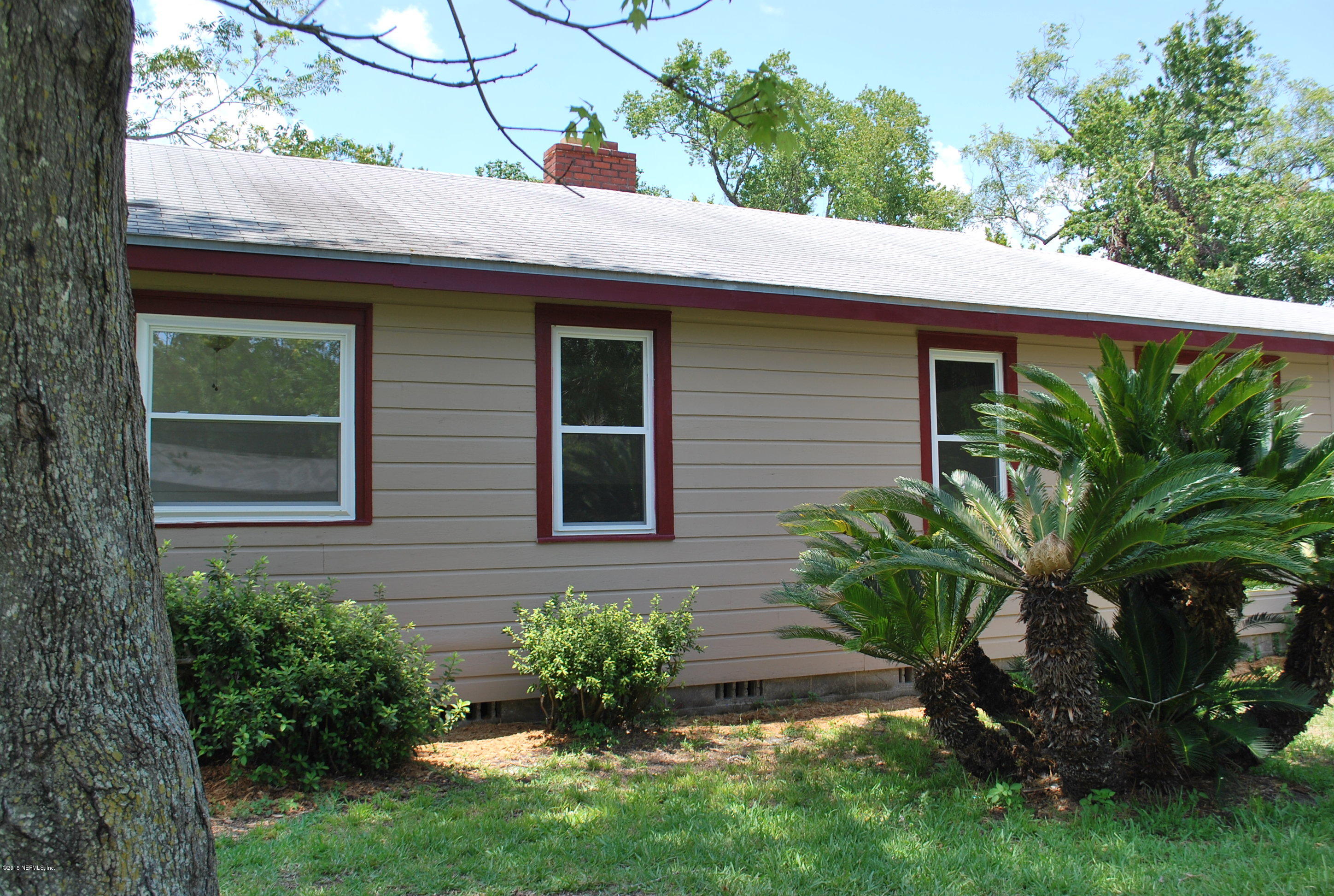 4603 Sunderland Road Jacksonville, FL 32210 - Photo 20 of 20 a view of a house with a small yard plants and a lawn chairs