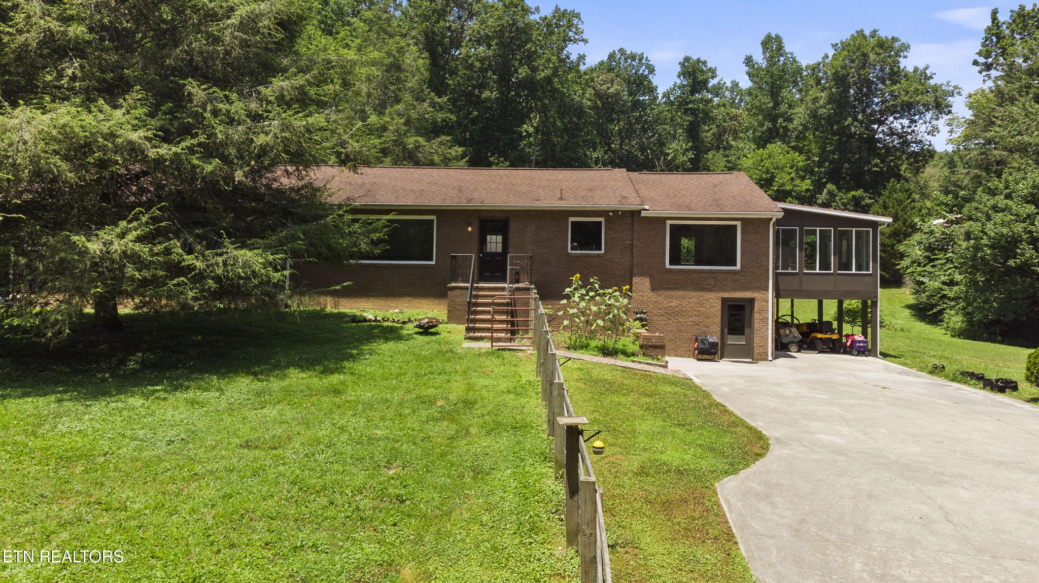 a front view of house with yard and green space