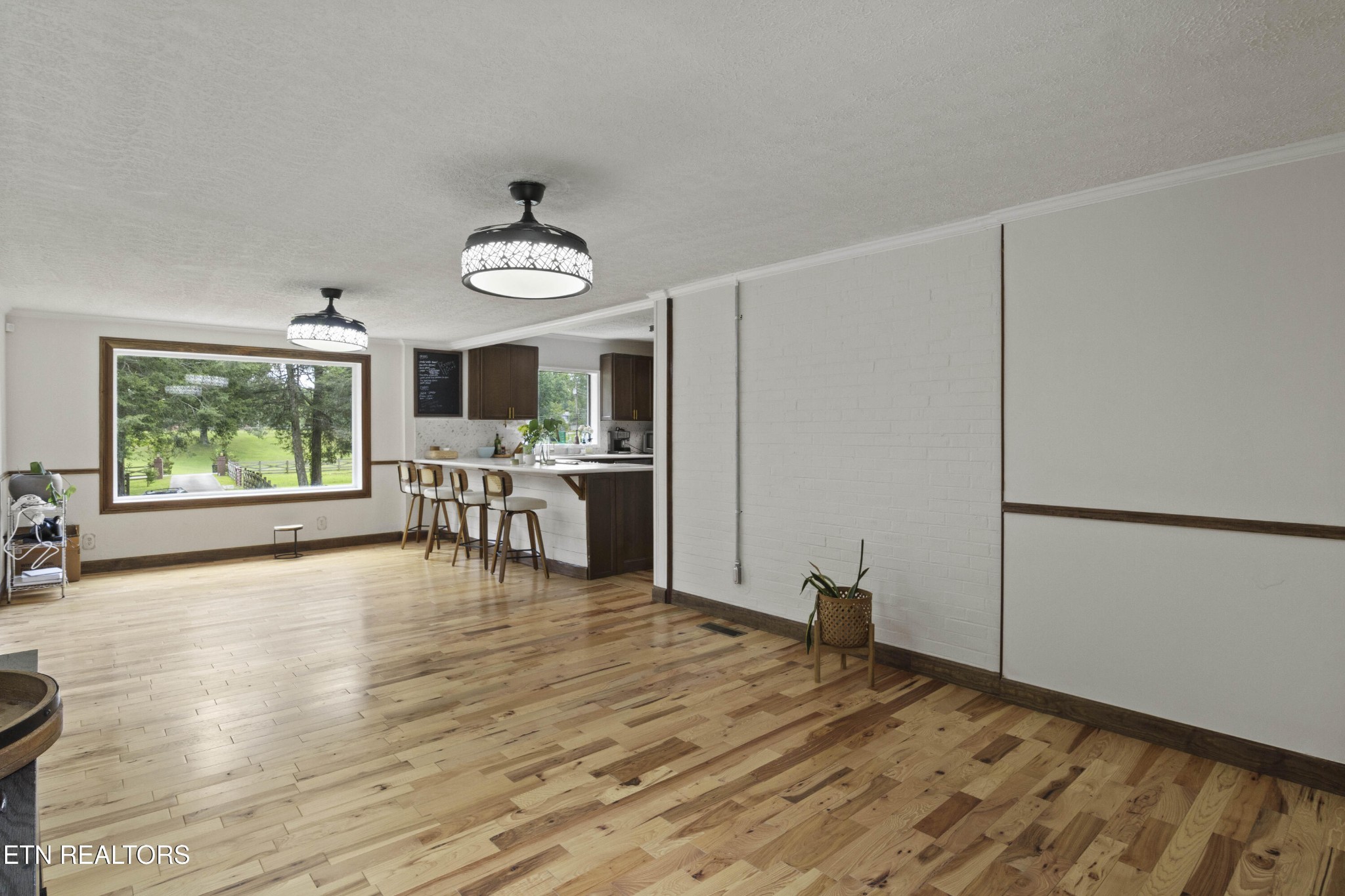 99 Reservoir Road Norris, TN 37828 - Photo 13 of 47 a view of an empty room with window and wooden floor