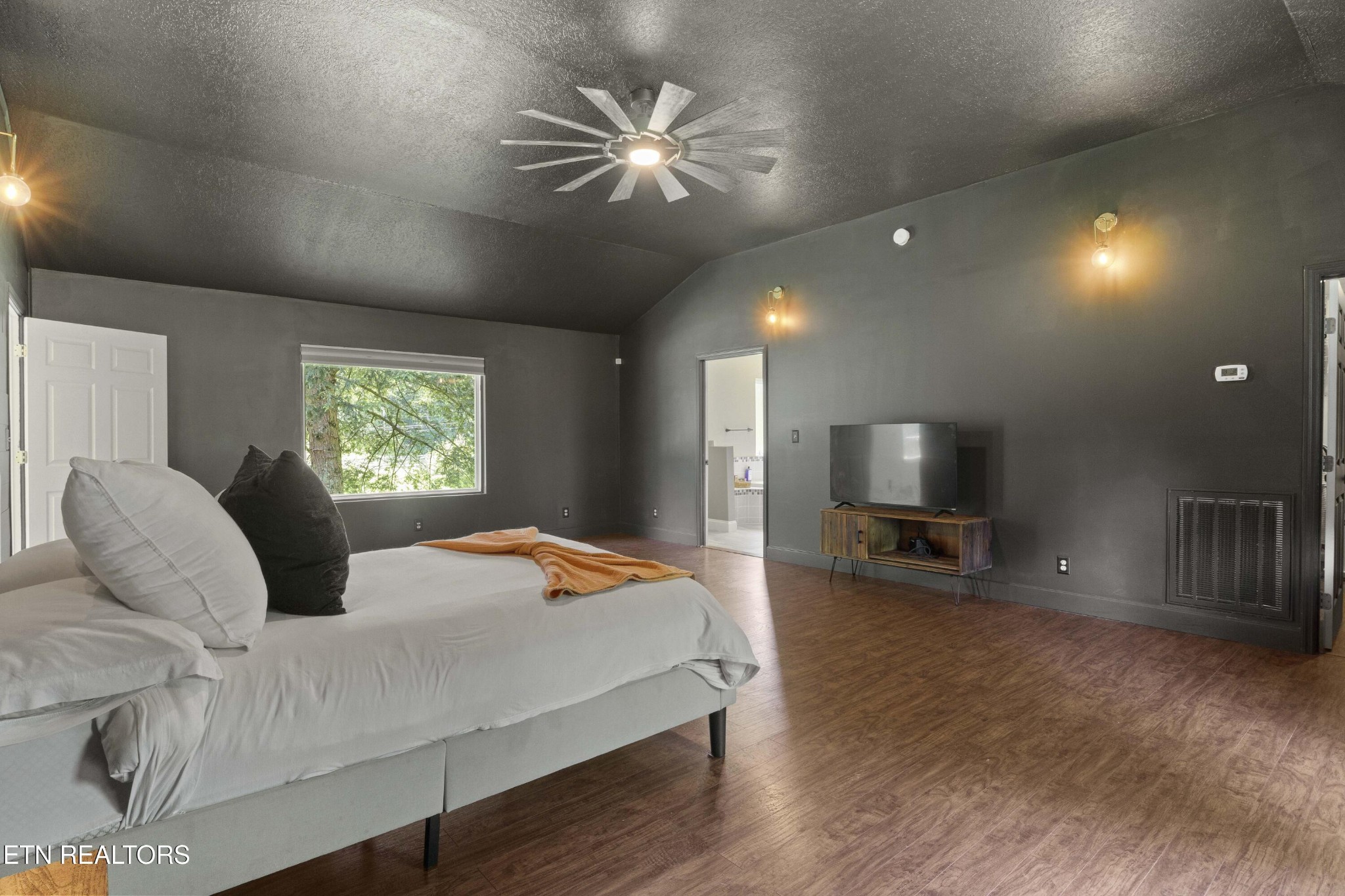 99 Reservoir Road Norris, TN 37828 - Photo 17 of 47 a bedroom with a bed and a flat screen tv