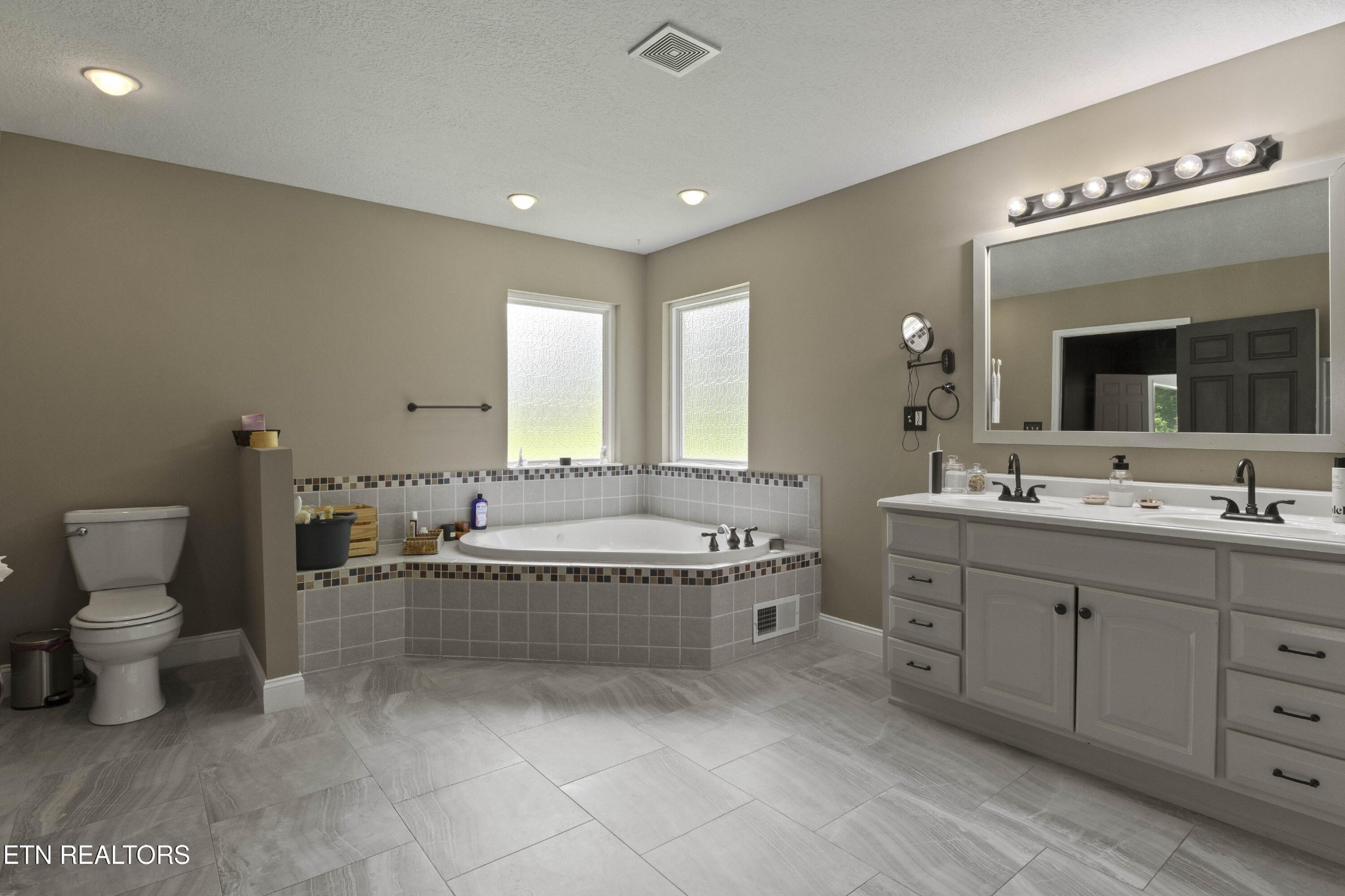 99 Reservoir Road Norris, TN 37828 - Photo 20 of 47 a spacious bathroom with a granite countertop sink and mirror