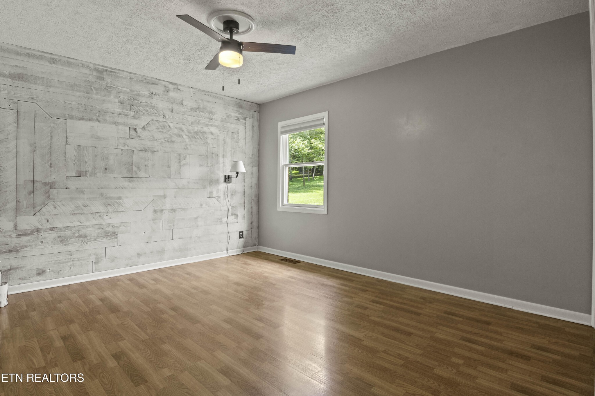 99 Reservoir Road Norris, TN 37828 - Photo 23 of 47 wooden floor in an empty room with a window