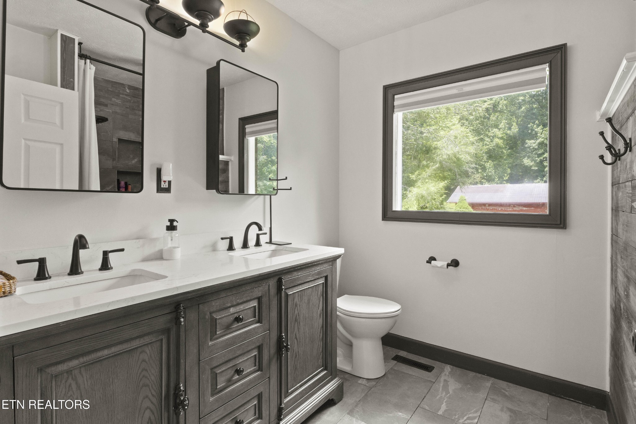 99 Reservoir Road Norris, TN 37828 - Photo 25 of 47 a bathroom with a toilet sink and mirror
