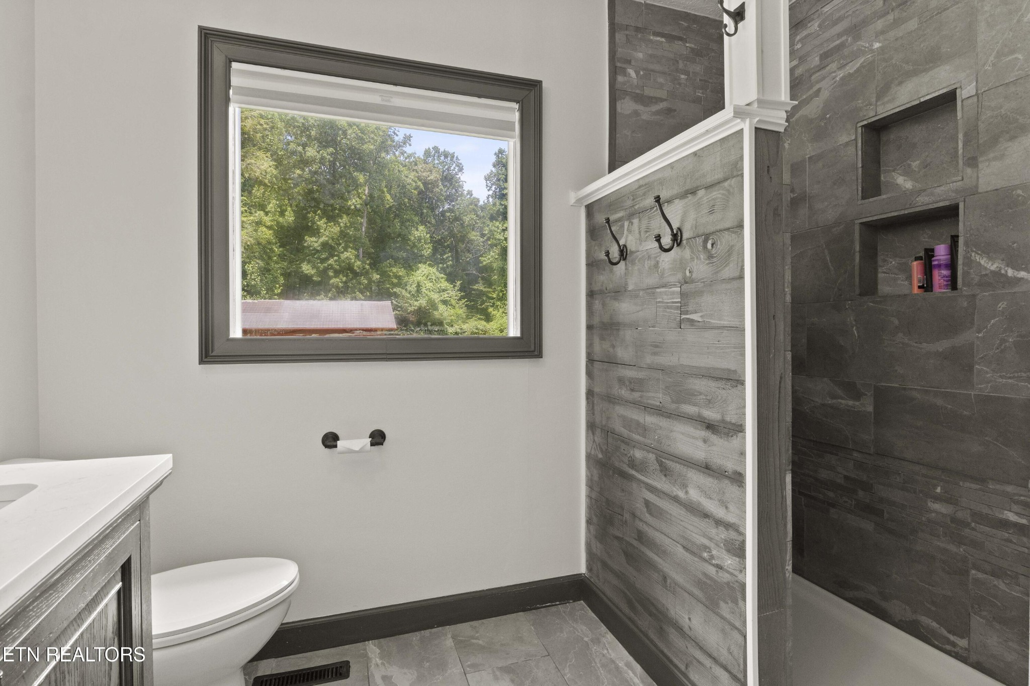 99 Reservoir Road Norris, TN 37828 - Photo 27 of 47 a bathroom with a toilet and a shower