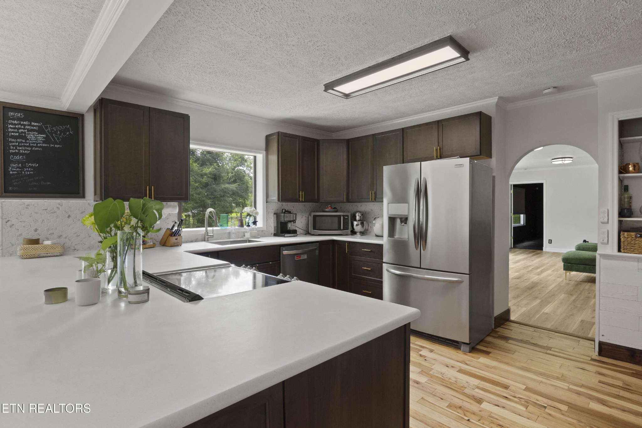 99 Reservoir Road Norris, TN 37828 - Photo 9 of 47 a kitchen with stainless steel appliances a refrigerator a sink a stove and cabinets