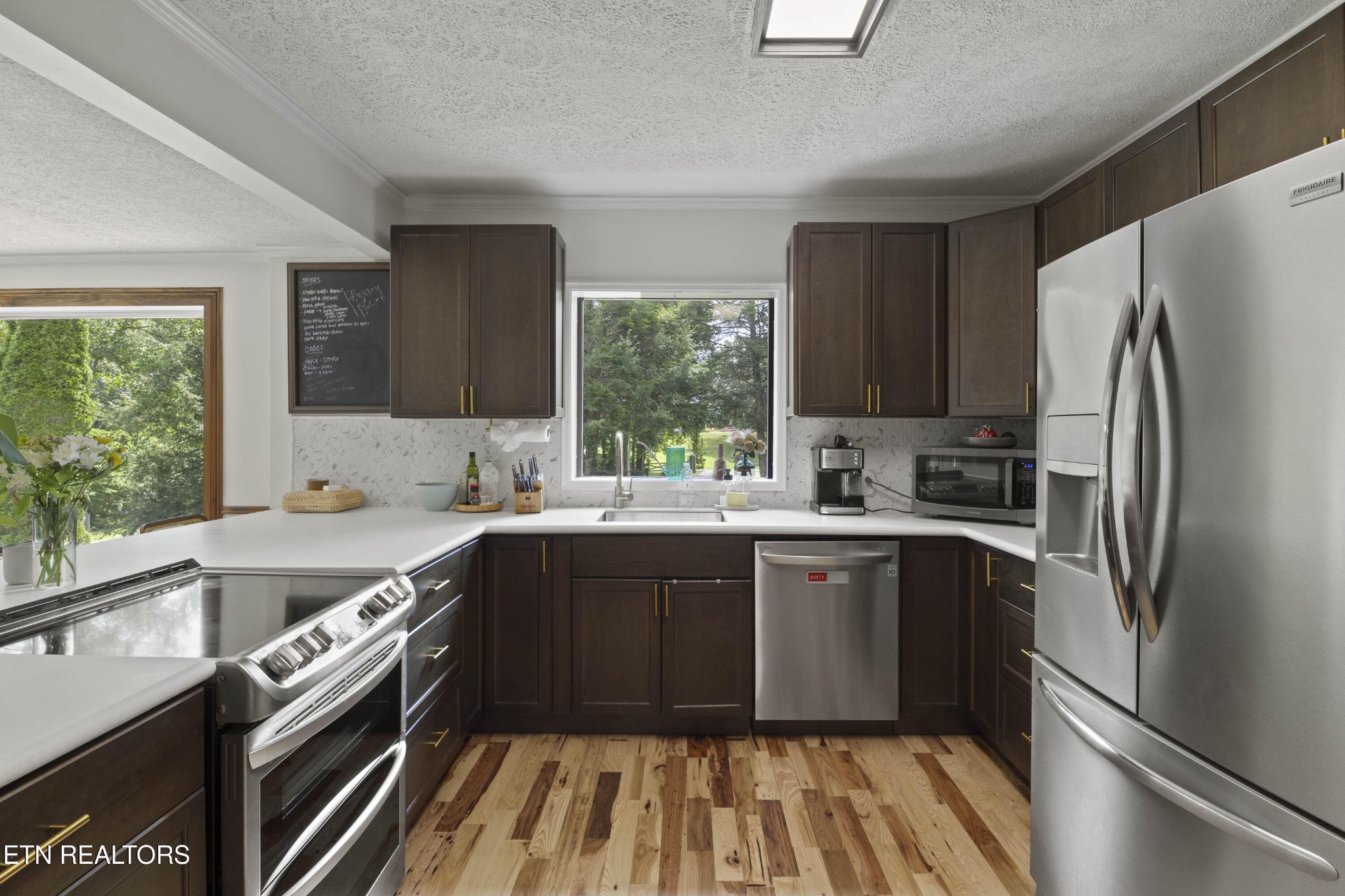 99 Reservoir Road Norris, TN 37828 - Photo 10 of 47 a kitchen with a sink stove and refrigerator