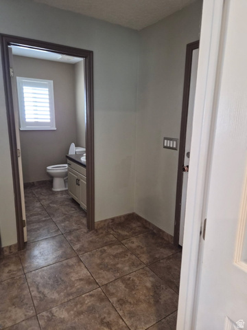 1697 West 2450 Vernal, UT 84078 - Photo 14 of 36 Bathroom featuring vanity and dark tile patterned floors