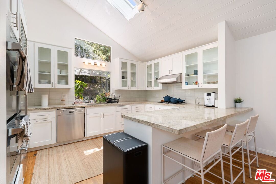 22760 Chamera Lane Topanga, CA 90290 - Photo 14 of 52 a kitchen with a stove a sink and a refrigerator